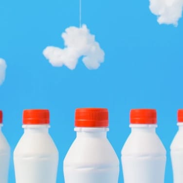 3 Milk bottles with clouds.